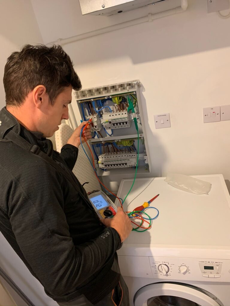 The APP Electrical Ltd Working on a consumer unit